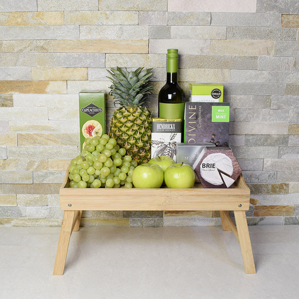 A glass of wine in your hand, an assortment of juicy fruits on a platter, and a spread of decadent snacks for your pleasure